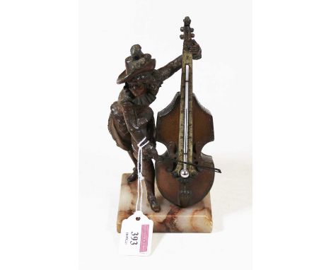 An early 20th centry bronzed metal novelty desktop thermometer in the form of man in period dress playing a cello, on marble 