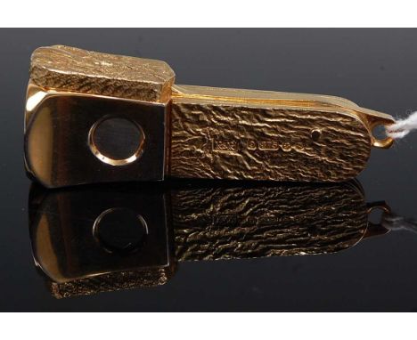 A modern 9ct gold mounted cigar cutter, having typical hinged action, the three applied gold panels naturalistically worked a