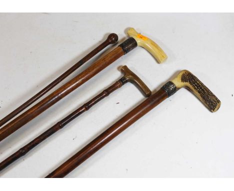 An early 20th century ivory handled walking stick with silver collar, 87cm, together with three other walking sticks