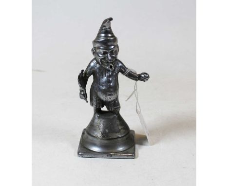 An early 20th century cast metal bar top cigar lighter in the form of Mr Punch, having a feather in one hand and cup in the o
