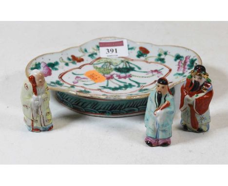A Chinese stoneware shallow bowl, of shaped oval form, enamel decorated with flowers, w.18cm; together with three figures of 
