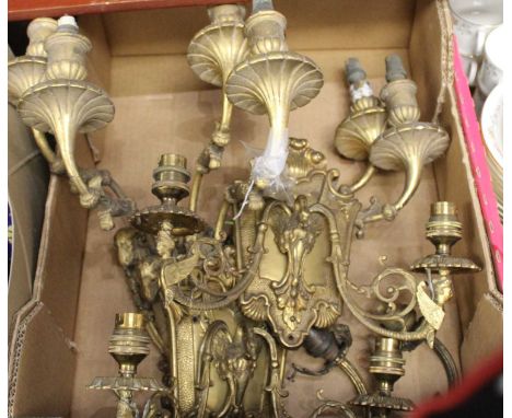 A pair of Rococo style gilt brass twin sconce wall light fittings, with rams head masks and lion mask terminal; together with