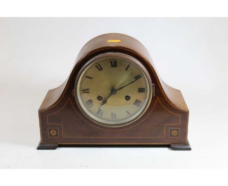 An early 20th century mahogany cased eight day mantel clock, the silvered dial showing Roman numerals, the case with box wood