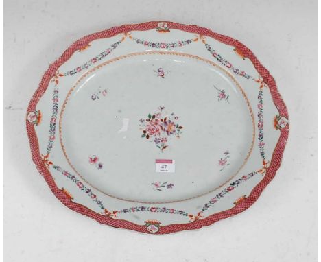 A stoneware meat dish of shaped oval form, enamel decorated with flowers within pink border, width 43cmCondition report: 3/4 