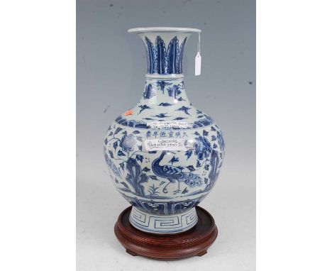 A Chinese export stoneware vase having a flared rim to a slender neck and bulbous lower body decorated with a peacock amidst 