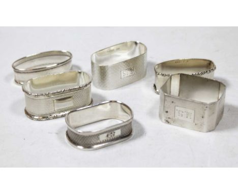 Six various English silver napkin rings, being either oval or rectangular, some with engine turned decoration, gross weight 3