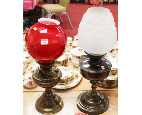 An early 20th century brass pedestal oil lamp, having red tinted opalescent glass shade; together with one other early 20th c
