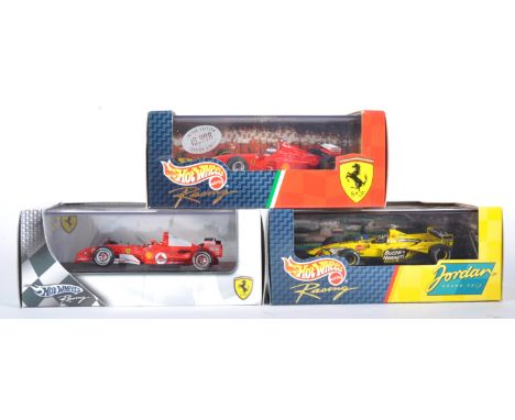 Three original Mattel made Hot Wheels 1/43 scale F1 Formula One diecast model racing cars. Models comprising F2005 Michael Sc