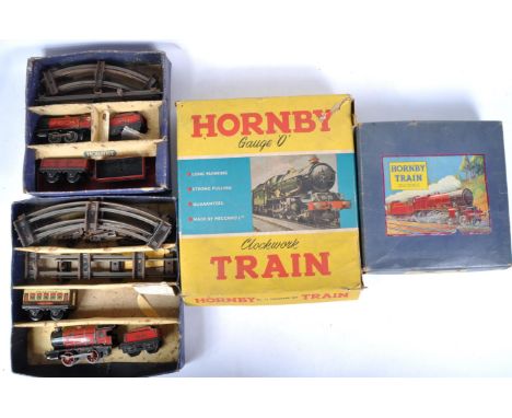 A collection of x4 vintage Hornby O gauge tinplate clockwork model railway trainset locomotive sets / Goods Sets. Each set co