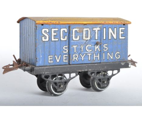 An original vintage Hornby O gauge tinplate rolling stock wagon ' Seccotine Sticks Everything ' van. The model generally appe