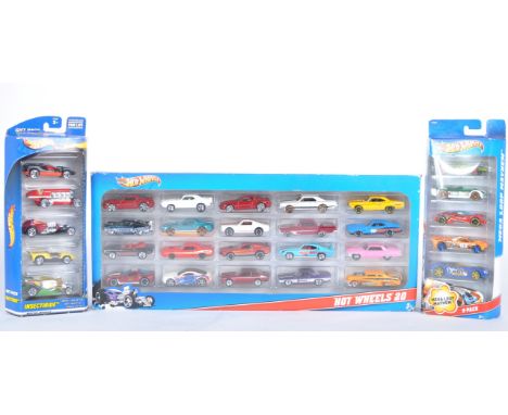 Three Mattel made Hot Wheels diecast box sets comprising Mega Loop Mayhem, Insectride and a x20 car pack. Contents appearing 