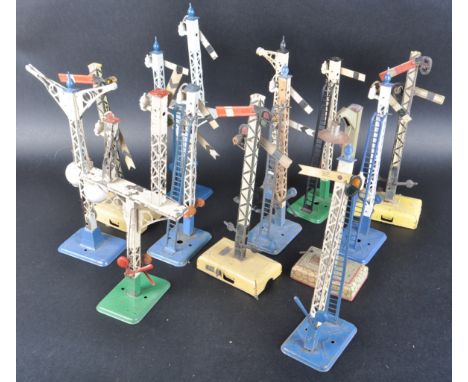 A collection of vintage Hornby O gauge tinplate model railway trainset trackside signal posts. Examples comprising double arm