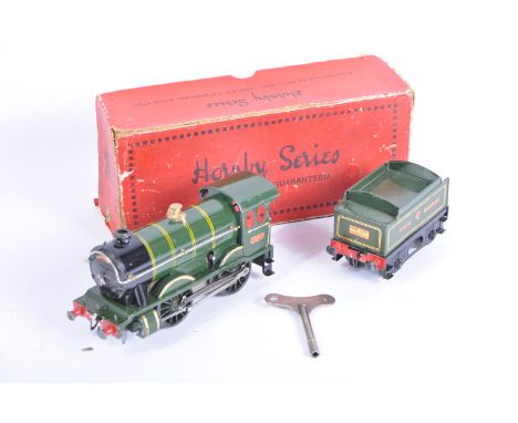 A vintage Hornby O gauge tinplate clockwork model railway trainset locomotive engine. The loco being a 0-4-0 GWR Great Wester