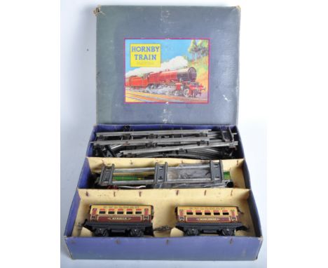 A vintage Hornby O gauge tinplate clockwork model railway trainset No. M1 Passenger Set. The set containing a 0-4-0 locomotiv