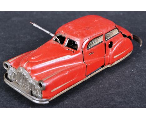 A vintage 1950s French ' Joustra ' made tinplate clockwork model car. The car with automatic turning, open and shutting bonne