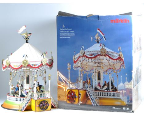 A Limited Edition German Marklin made hand cranked musical carousel. The model featuring x4 gondolas, x4 horses and x12 figur