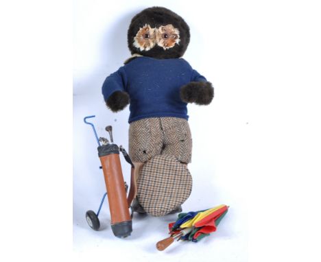 A vintage mid 20th Century stuffed toy teddy bear in the form of an Owl in a novelty golfing outfit comprising tweed shorts a