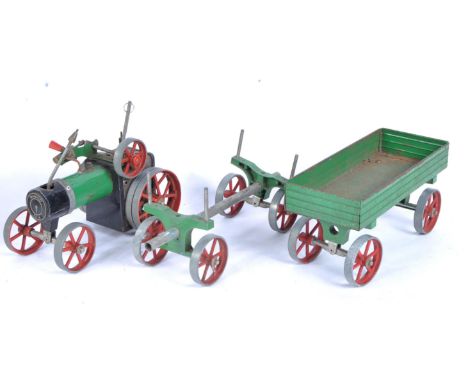 A vintage Mamod live steam traction engine No. TE1A along with the OW1 Open Wagon Trailer and log trailer / wheels. The engin