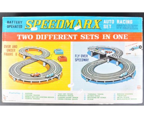 An original vintage Louis Marx made ' Speedmarx 'battery operated slot car racing set. The set containing x2 cars, x2 control