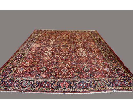 MAHAL CARPET, West Iran, circa 1930, the brick red field with an all over design of angular serrated leafy vines and polychro