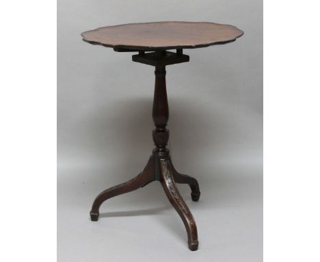 GEORGE III MAHOGANY BIRDCAGE TRIPOD TABLE, the shaped circular top with a beaded rim on a baluster column and harebell carved