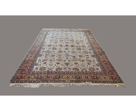 TABRIZ CARPET, Iranian Azerbaijan, circa 1950, the ivory lattice field with an allover design of flower heads and palmettes e