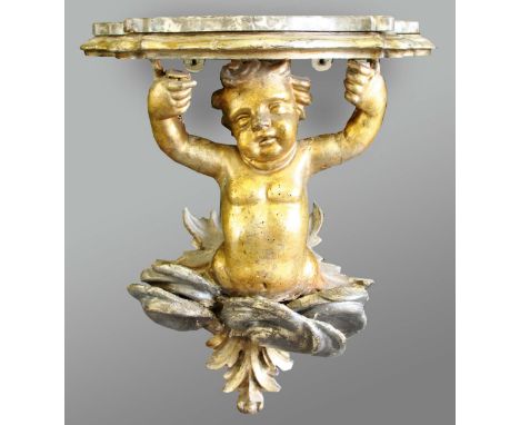 GILTWOOD CHERUB WALL BRACKET, with silvered clouds and a serpentine, marble topped shelf, height 50cm