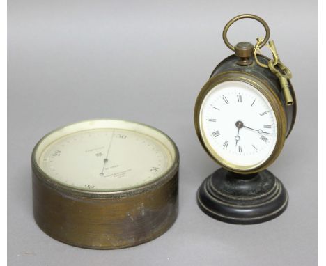 VICTORIAN BRASS, OVAL TIMEPIECE, the enamelled dial on a brass, eight day movement, on a stepped circular base, with key, hei