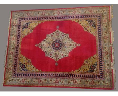 CARPET OF TABRIZ DESCENT, probably Romania, circa 1950, the blood red field centred by an ivory and indigo medallion framed b