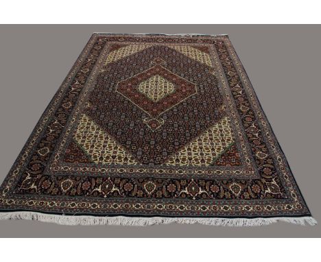 TABRIZ CARPET, Iranian Azerbaijan, circa 1965, the indigo and ivory Herati field centred by a stepped medallion, framed by sp
