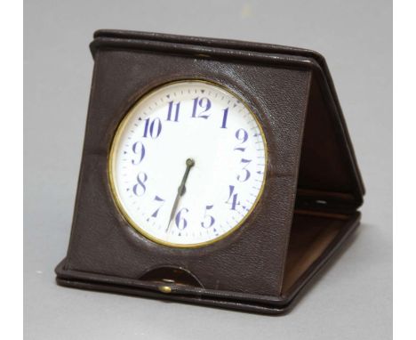 LEATHER CASED TRAVEL CLOCK, the 3 3/4" enamelled dial with blue arabic numerals on a manual wind pocket watch movement inscri