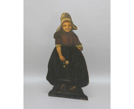 DUMMY BOARD STICK STAND, 19th century, the carved and painted oak figure of a Dutch girl holding a drooping flower and wearin