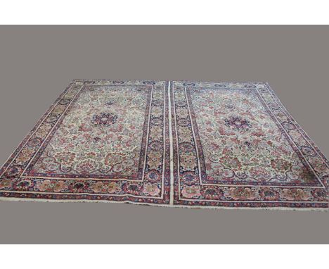 KIRMAN CARPET, South East Iran, circa 1940, woven as one piece in the format of rugs, each with an ivory field of naturalisti