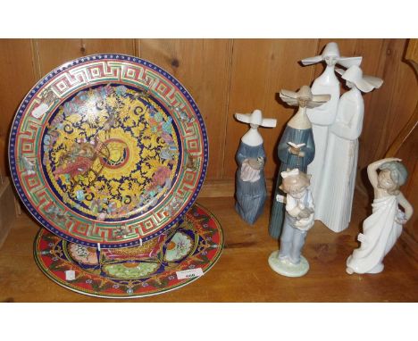 Two boxed Rosenthal Versace Christmas plates 2004 and 2005 (boxed), together with some Lladro and Nao nuns and child figurine