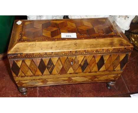 Fine Georgian parquetry tea caddy with carved wood handles, raised on turned  and having original glass mixing bowl, 31cm wid