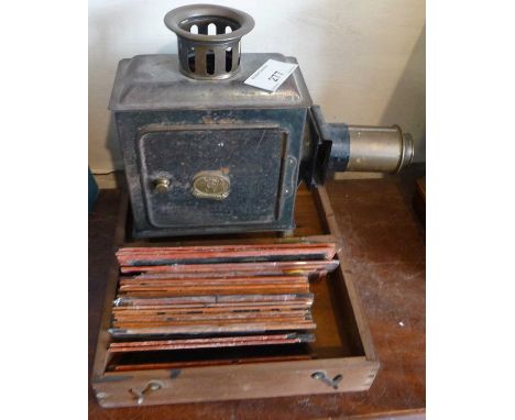 Victorian German tinplate toy magic lantern with collection of slides