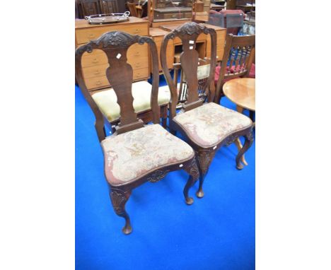 A pair of 19th Century dining chairs having vase backs, tapestry seats and cabriole legs with carved detailing