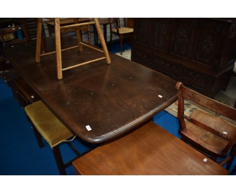 A dark stained Ercol refectory style dining table