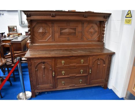 A late Victorian Gillow's of Lancaster oak sideboard, with raised and panelled back with barley twist supports over three cen
