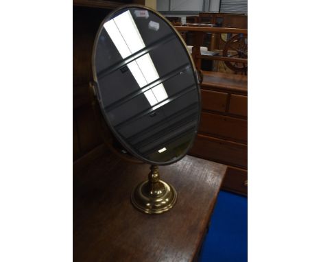 A vintage toilet mirror having brass frame and stand