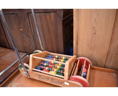 A vintage pushalong toy 'busy baby' and an abacus