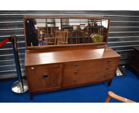 A vintage Remploy dressing table having three long drawers and cupboard to base