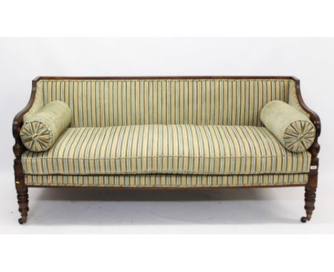 Good Regency mahogany framed sofa with reeded show-wood frame and striped upholstery on ring turned legs and brass castors CO