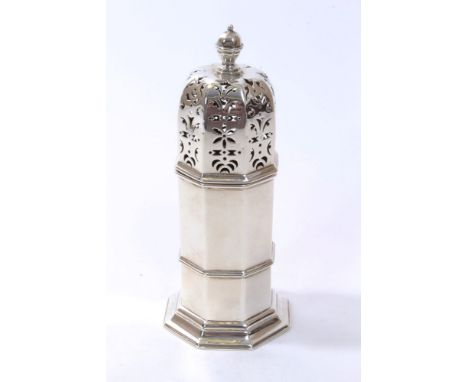 Victorian silver sugar caster of octagonal lighthouse form, with ornate pierced slip-in cover and domed finial, on an octagon