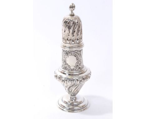 Large Victorian silver sugar caster of wrythen baluster form, with embossed scroll and floral decoration and flame finial, on