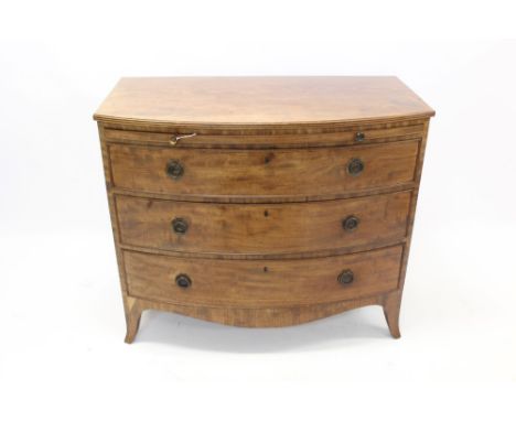 Good George III mahogany bow front chest with brushing slide and three graduated drawers, each with brass drop handles, on sp