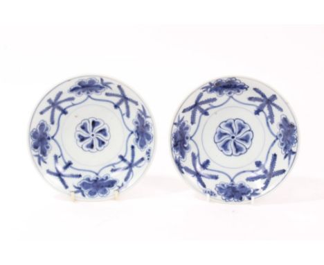 Pair late 17th century Chinese blue and white saucer dishes with painted floral mons - seal marks to bases, 17cm diameter