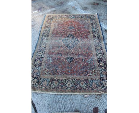 Antique Kashan silk carpet with foliate arabesque ornament on brick red ground in multiple borders