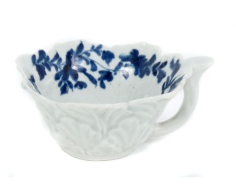 Mid-18th century Worcester blue and white leaf moulded butter boat, circa 1755, with painted floral spray and moulded leaf de