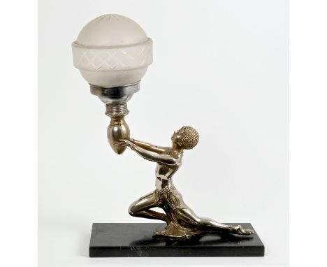 Art Deco silvered table lamp in the form of a sinuous semi-clad female kneeling figure, holding aloft a torch, with frosted g